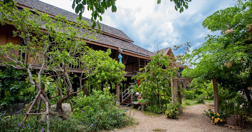 The teak house at Chiang Mai Montessori school set in the lush green gardens
